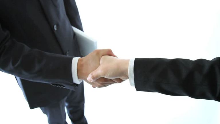 798345070-business-transaction-compromise-business-attire-handshake